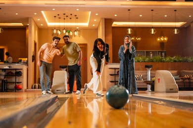Saudi Friends Playing Bowling at Indoor Recreation Center