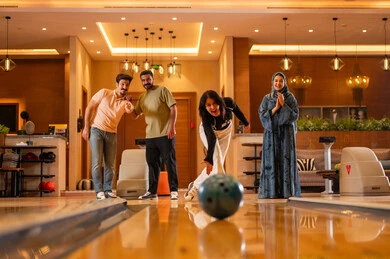 Saudi Friends Playing Bowling in Modern Entertainment Center