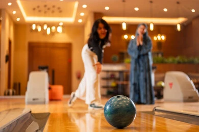 Saudi Women Playing Bowling in Indoor Entertainment Alley