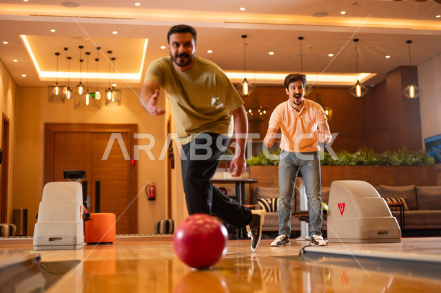 Saudi Men Playing Bowling in Indoor Recreation Center