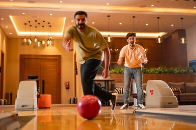 Saudi Men Playing Bowling in Indoor Recreation Center