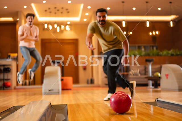 Saudi Men Playing Bowling in Indoor Recreation Center