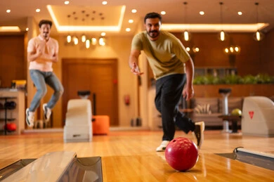 Saudi Men Playing Bowling in Indoor Recreation Center