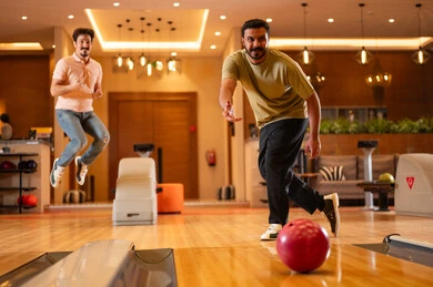 Arab Men Playing Bowling in Indoor Recreation Center