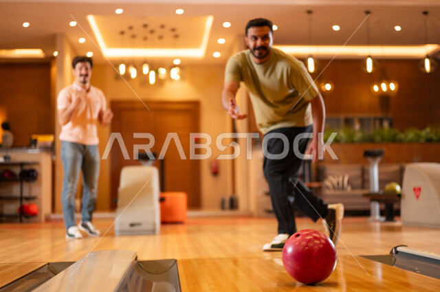Saudi Men Playing Bowling in Indoor Recreation Center