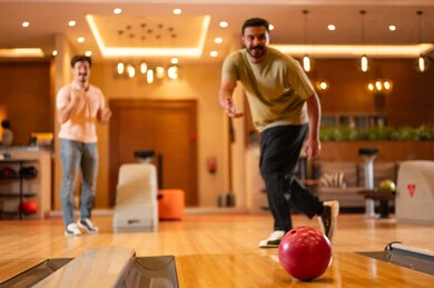 Saudi Men Playing Bowling in Indoor Recreation Center
