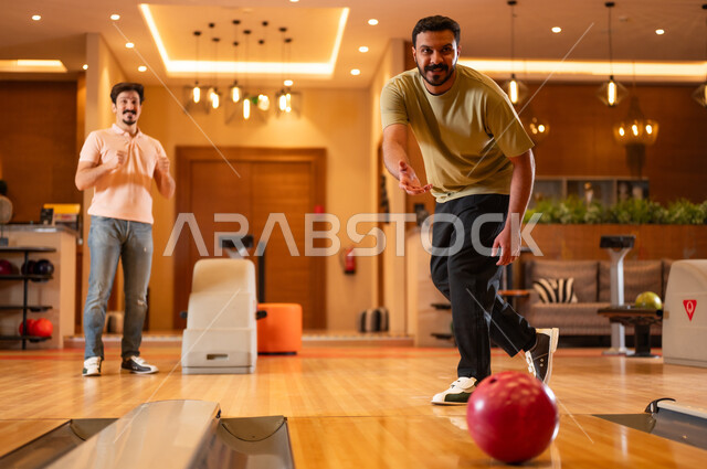 Saudi Men Playing Bowling in Modern Indoor Alley