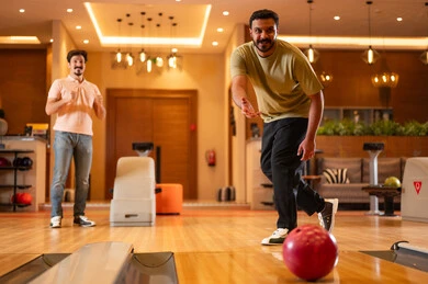 Saudi Men Playing Bowling in Modern Indoor Alley