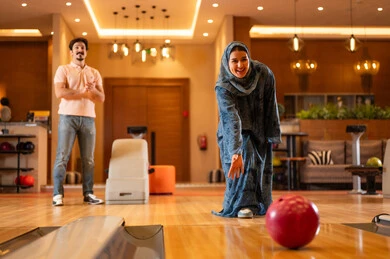 Saudi Woman Bowling in Abaya at Recreation Center