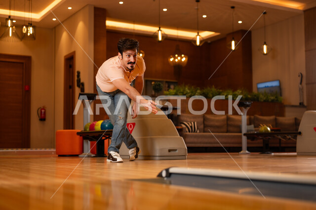 Saudi Man Playing Bowling in Recreation Center