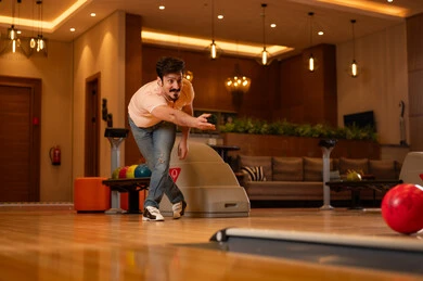 Middle Eastern Man Playing Bowling in Indoor Center