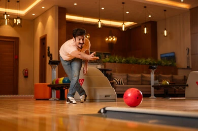 Saudi Man Playing Bowling in Modern Indoor Center
