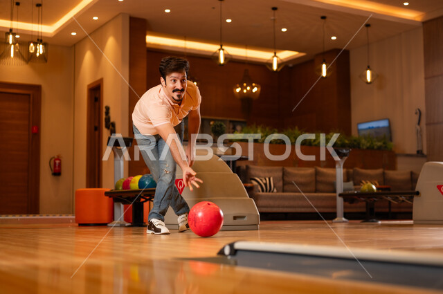 Arab Man Playing Bowling in Modern Indoor Alley
