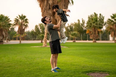 Saudi Father and Son Playing in Public Park
