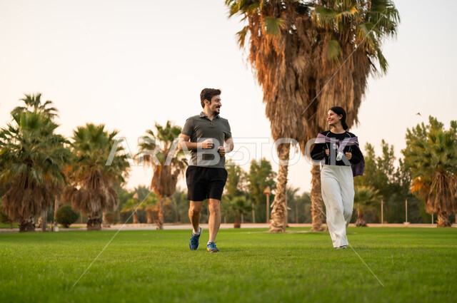 Arab Couple Jogging in Green Park with Palm Trees
