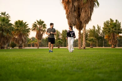 Arab Couple Walking in Park During Golden Hour