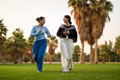 Saudi Women Walking and Laughing in Public Park