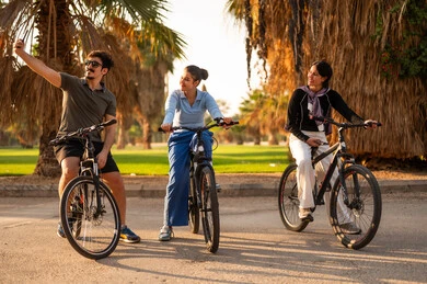 Arab Friends Cycling and Taking Selfie in Park