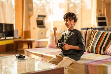 Saudi Boy Playing Video Games at Home