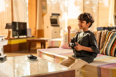 Saudi Boy Celebrating While Playing Video Games at Home