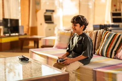 Middle Eastern Boy Playing Video Games at Home