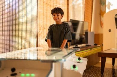 Young Saudi Boy Playing Arcade Game at Home