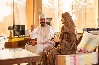 Omani Couple Playing Video Games in Traditional Dress