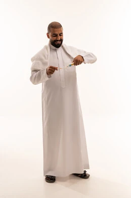 Saudi Man Applying Toothpaste to Brush in Studio