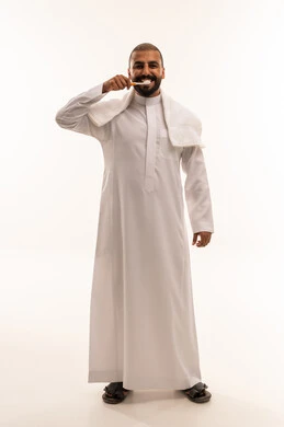 Saudi Man in Thobe Brushing Teeth on White Background