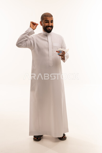 Saudi Man in White Thobe Cleaning Ear with Cotton Swab