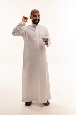 Saudi Man in White Thobe Cleaning Ear with Cotton Swab