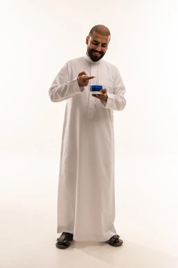 Arab Man in White Thobe Holding Skincare Cream Jar