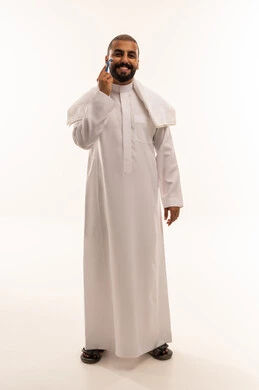 Saudi Man Shaving with Razor in Traditional Thobe