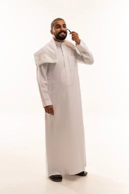 Saudi Man Shaving with Razor on White Background