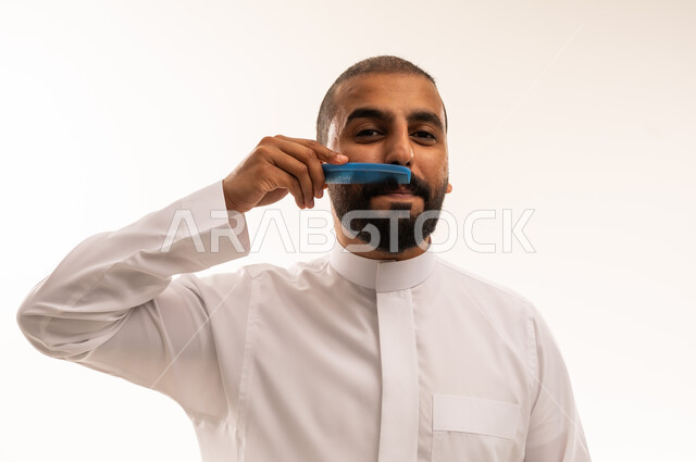 Saudi Man Grooming Mustache in White Thobe