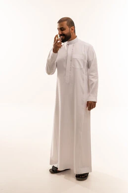 Saudi Man in White Thobe Smelling Perfume