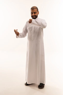Saudi Man in White Thobe Smelling Perfume in Studio