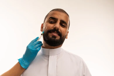 Saudi Man Receiving Cosmetic Facial Injection in Clinic