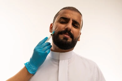 Saudi Man Receiving Facial Injection in White Thobe