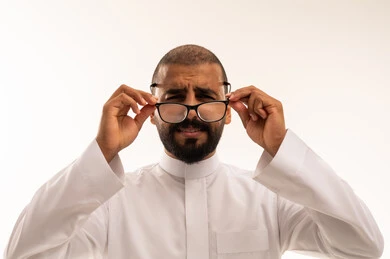 Saudi Man in Thobe Holding Eyeglasses Studio Shot