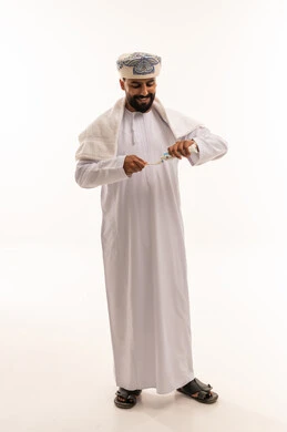Omani Man Brushing Teeth in Traditional Dress