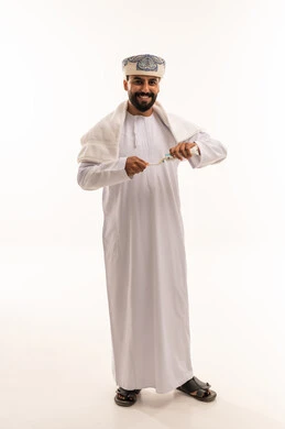 Omani Man in Traditional Dress Holding Miswak