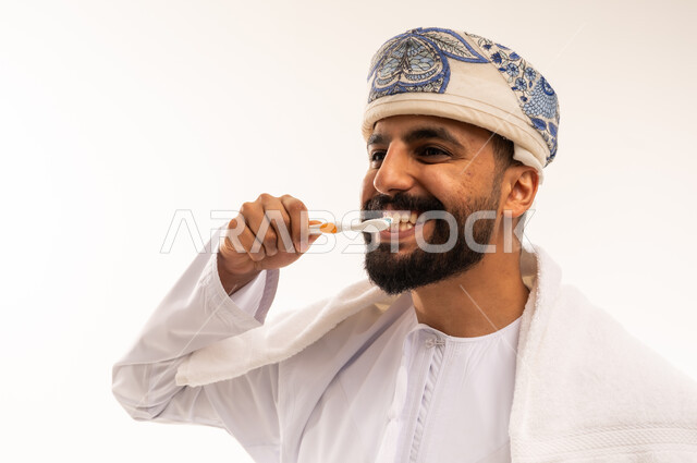 Omani Man Brushing Teeth in Traditional Dress