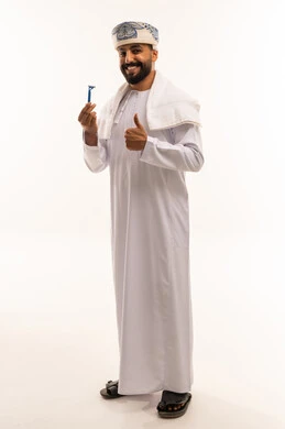Omani Man with Shaving Razor and Thumbs Up Gesture