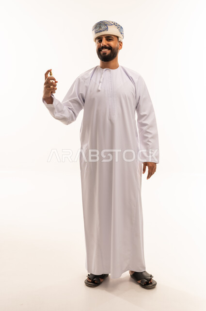 Omani Man in Traditional Dishdasha Holding Perfume