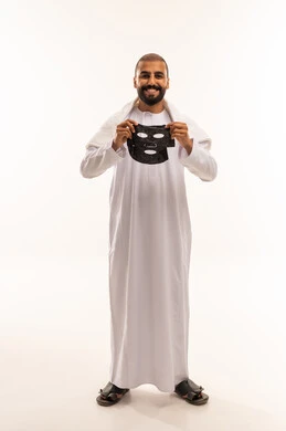 Omani Man in Traditional Dress Holding Skincare Facial Mask