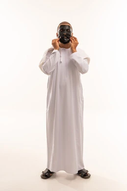 رجل عماني بالدشداشة يضع قناع وجه أسود