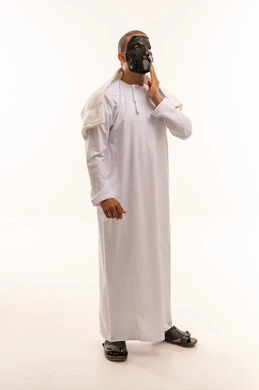 Omani Man Applying Black Face Mask in Studio