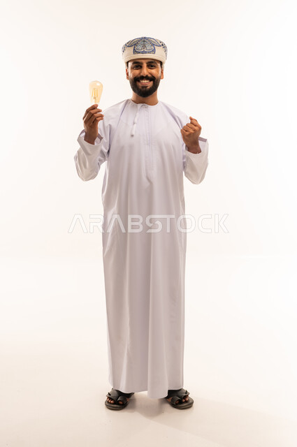 Omani Man Holding Light Bulb with Success Gesture