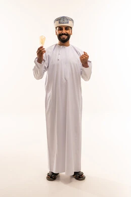 Omani Man Holding Light Bulb with Success Gesture